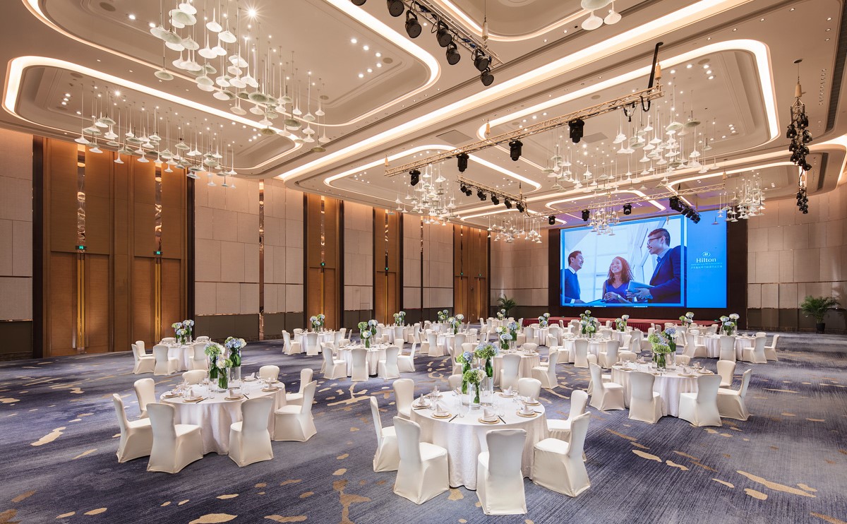 鲁能大宴会厅圆桌摆台，宴会厅装饰风格豪华而现代-济南鲁能希尔顿酒店及公寓